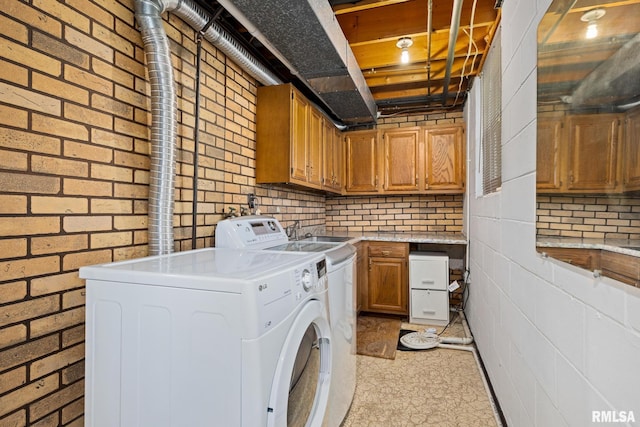 3524 W Saymore Ln, Peoria, IL 61615 - laundry room featuring cabinet space, washing machine and clothes dryer, and brick wall