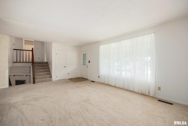 3524 W Saymore Ln, Peoria, IL 61615 - unfurnished living room with stairway and carpet floors