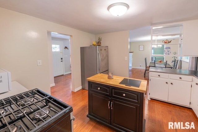 926 Birchwood Dr, Washington, IL 61571 - kitchen featuring range with gas cooktop, freestanding refrigerator, white cabinetry, and light wood-type flooring