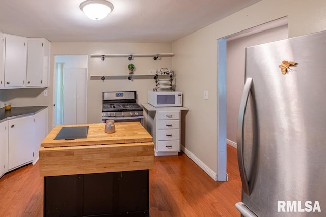 926 Birchwood Dr, Washington, IL 61571 - kitchen featuring appliances with stainless steel finishes, wooden counters, white cabinetry, light wood finished floors, and open shelves