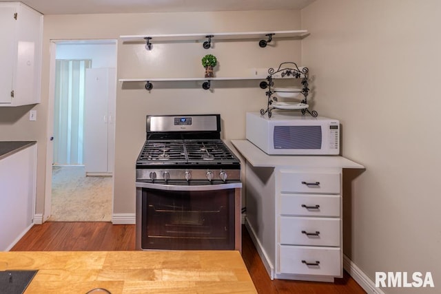 926 Birchwood Dr, Washington, IL 61571 - kitchen featuring white microwave, gas stove, wood finished floors, and white cabinetry