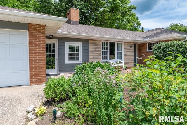 926 Birchwood Dr, Washington, IL 61571 - view of front of property featuring a chimney, brick siding, a garage, and roof with shingles