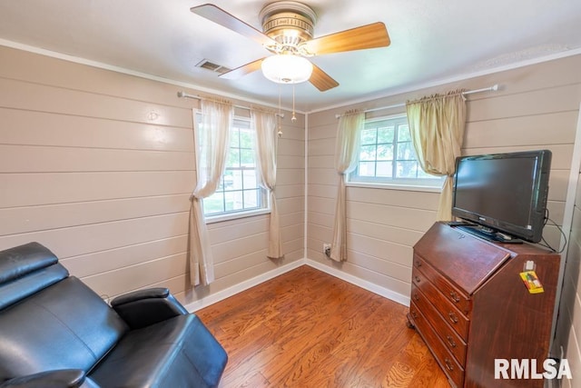 926 Birchwood Dr, Washington, IL 61571 - sitting room with light wood finished floors, a ceiling fan, ornamental molding, and wooden walls