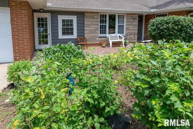 926 Birchwood Dr, Washington, IL 61571 - property entrance featuring brick siding, a garage, and a shingled roof