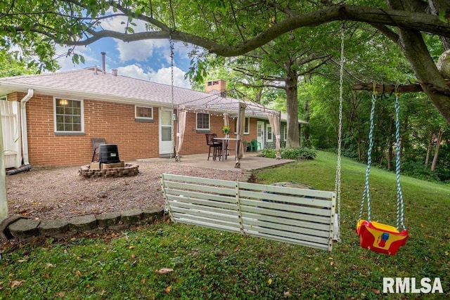 926 Birchwood Dr, Washington, IL 61571 - rear view of house with brick siding, a patio, a lawn, and a chimney