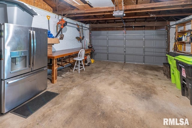 926 Birchwood Dr, Washington, IL 61571 - garage featuring stainless steel fridge and a garage door opener