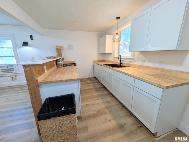 218 Meadow Lawn St, Manito, IL 61546 - kitchen with wood counters, white cabinetry, light wood finished floors, and decorative light fixtures