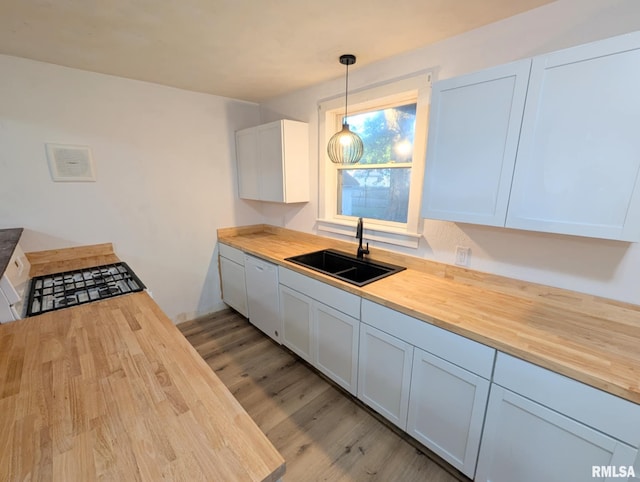 218 Meadow Lawn St, Manito, IL 61546 - kitchen with butcher block counters, light wood-style floors, white dishwasher, and hanging light fixtures