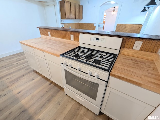 218 Meadow Lawn St, Manito, IL 61546 - kitchen with white gas range oven, butcher block counters, light wood-style flooring, ceiling fan, and white cabinets