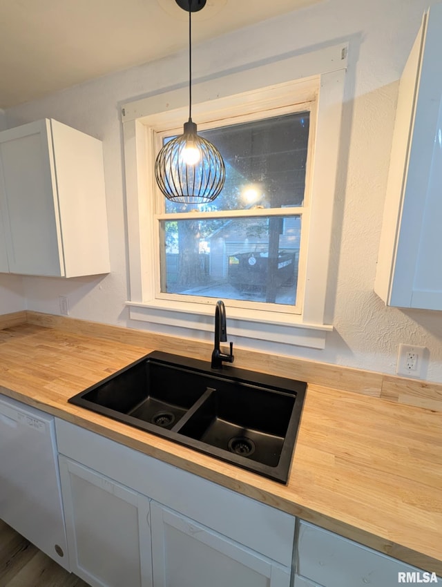 218 Meadow Lawn St, Manito, IL 61546 - kitchen with butcher block counters, white dishwasher, and hanging light fixtures