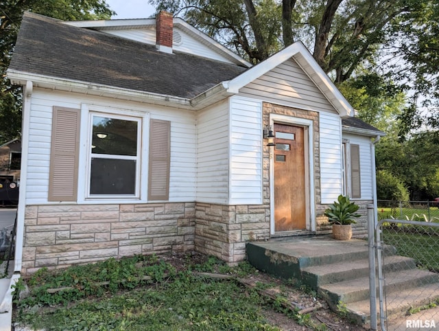 218 Meadow Lawn St, Manito, IL 61546 - view of front of house featuring stone siding and roof with shingles