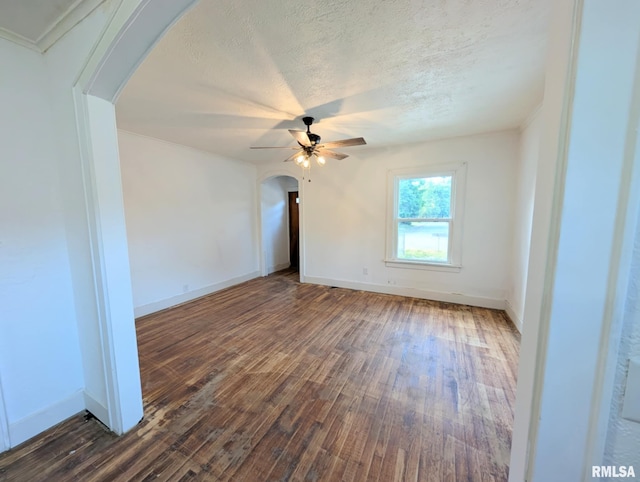 218 Meadow Lawn St, Manito, IL 61546 - unfurnished room with arched walkways, a ceiling fan, dark wood-style flooring, and a textured ceiling