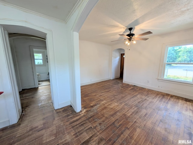 218 Meadow Lawn St, Manito, IL 61546 - spare room with arched walkways, ceiling fan, dark wood-type flooring, crown molding, and a textured ceiling