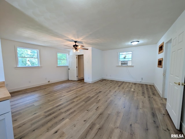 218 Meadow Lawn St, Manito, IL 61546 - unfurnished living room with light wood finished floors and ceiling fan