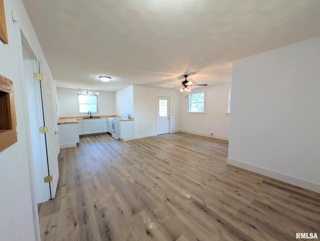218 Meadow Lawn St, Manito, IL 61546 - unfurnished living room featuring light wood finished floors and a ceiling fan