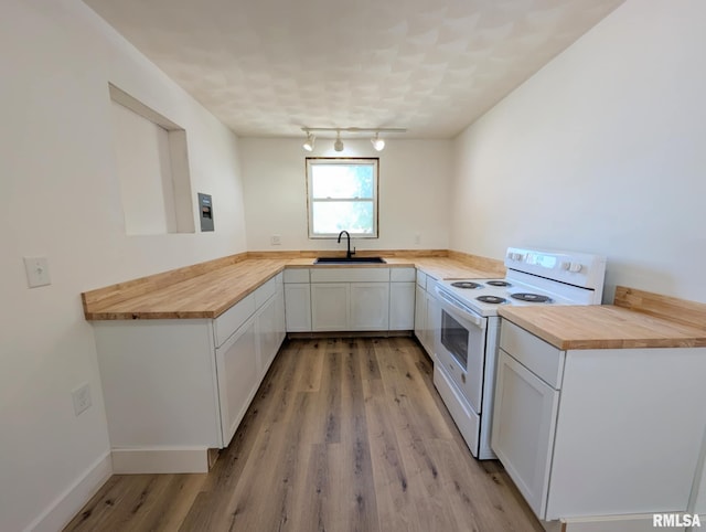 218 Meadow Lawn St, Manito, IL 61546 - kitchen with white electric range, butcher block countertops, light wood finished floors, white cabinets, and rail lighting