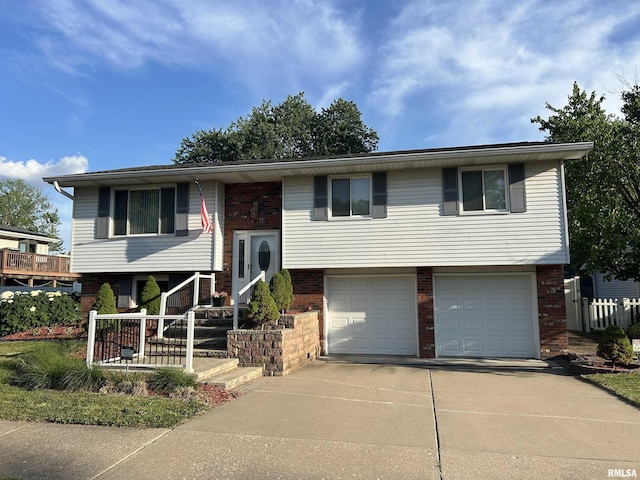 3406 W Brookside Dr, Peoria, IL 61615 - raised ranch featuring brick siding, a garage, and concrete driveway