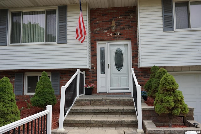 3406 W Brookside Dr, Peoria, IL 61615 - doorway to property with brick siding and a garage