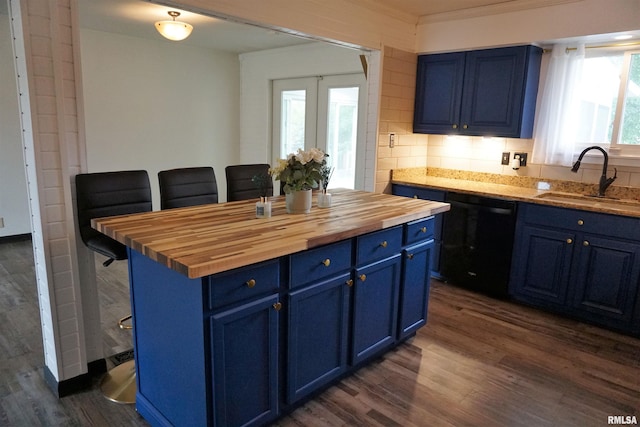 3406 W Brookside Dr, Peoria, IL 61615 - kitchen with blue cabinets, black dishwasher, wood counters, dark wood-type flooring, and a breakfast bar area