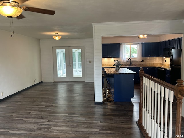 3406 W Brookside Dr, Peoria, IL 61615 - kitchen featuring black appliances, decorative backsplash, blue cabinets, and dark wood-style floors