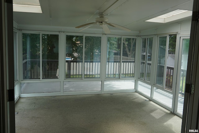3406 W Brookside Dr, Peoria, IL 61615 - unfurnished sunroom featuring a skylight, ceiling fan, and carpet floors