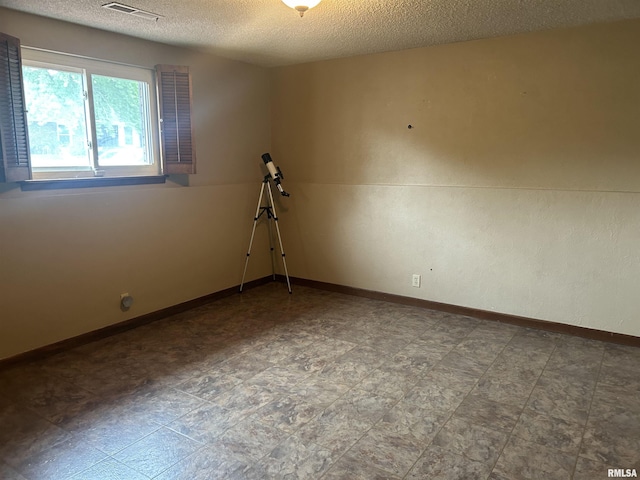 3406 W Brookside Dr, Peoria, IL 61615 - empty room with a textured ceiling and baseboards