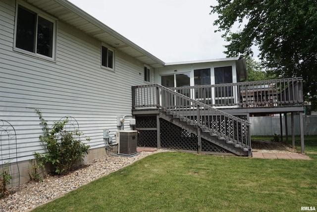 3406 W Brookside Dr, Peoria, IL 61615 - back of house featuring stairs, a sunroom, a deck, and a lawn