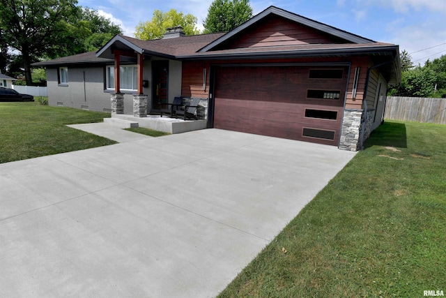 4527 N Nelson Dr, Peoria, IL 61614 - view of front of home with a garage, driveway, a chimney, and stone siding