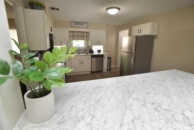 4527 N Nelson Dr, Peoria, IL 61614 - kitchen featuring appliances with stainless steel finishes, white cabinetry, and tasteful backsplash