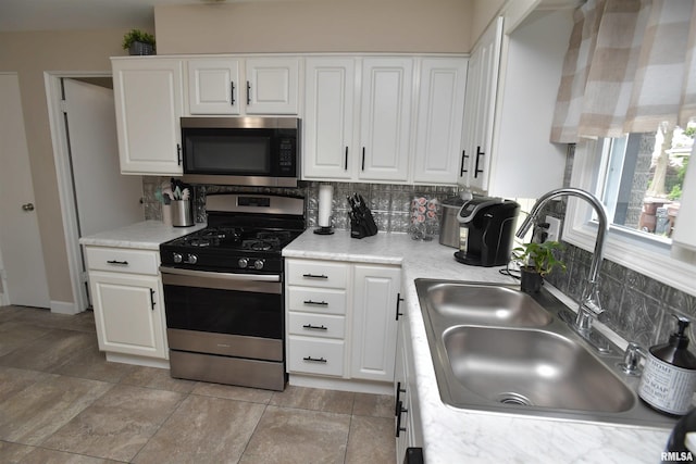 4527 N Nelson Dr, Peoria, IL 61614 - kitchen featuring appliances with stainless steel finishes, tasteful backsplash, white cabinets, and light countertops