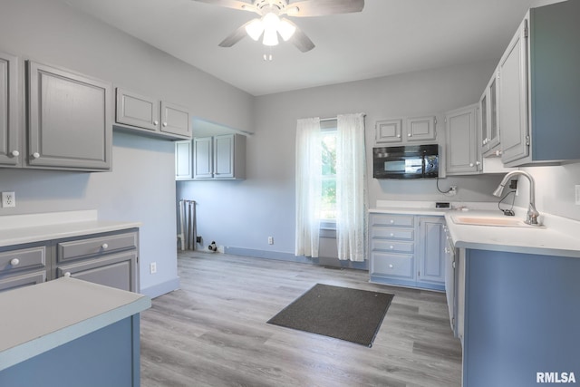 5610 W Lakeshore Dr, Princeville, IL 61559 - kitchen with black microwave, ceiling fan, light countertops, and light wood-style flooring