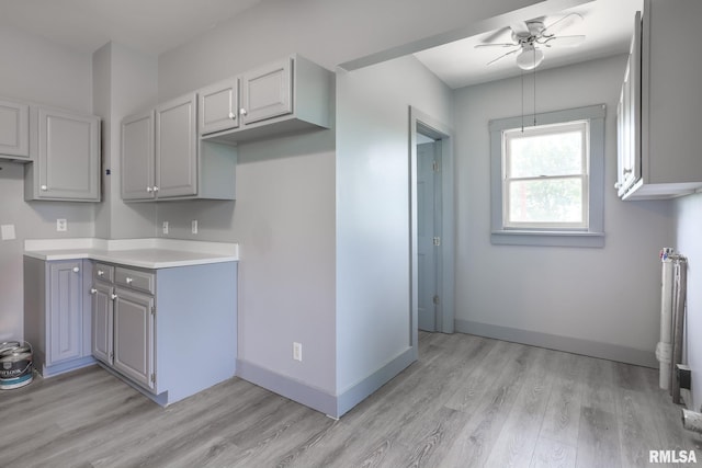 5610 W Lakeshore Dr, Princeville, IL 61559 - kitchen featuring ceiling fan, light wood-type flooring, light countertops, and gray cabinets