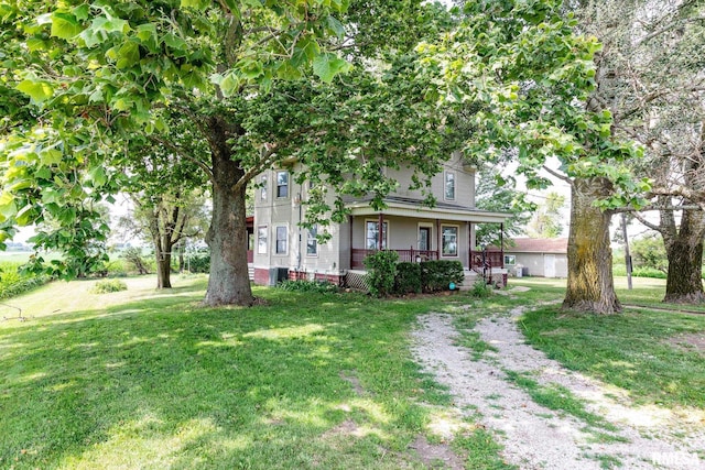 5610 W Lakeshore Dr, Princeville, IL 61559 - view of front of house with a porch and a front lawn