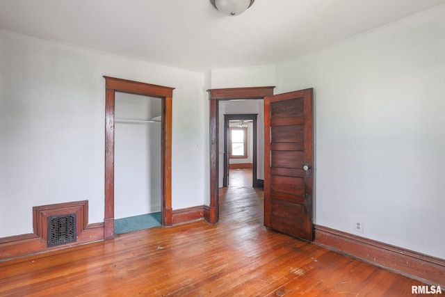 5610 W Lakeshore Dr, Princeville, IL 61559 - unfurnished bedroom featuring hardwood / wood-style flooring and a closet