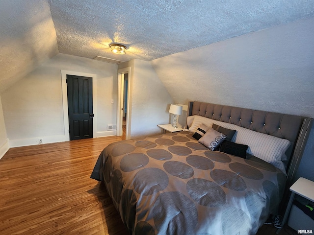 600 E Jefferson St, Washington, IL 61571 - bedroom with lofted ceiling, wood finished floors, and a textured ceiling
