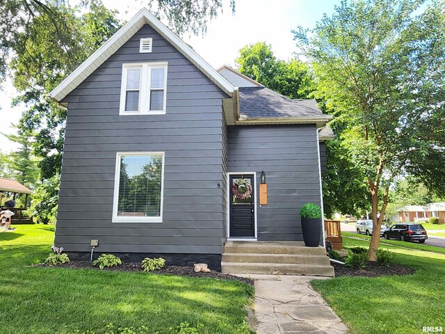 600 E Jefferson St, Washington, IL 61571 - view of front of property with a front lawn, entry steps, and roof with shingles