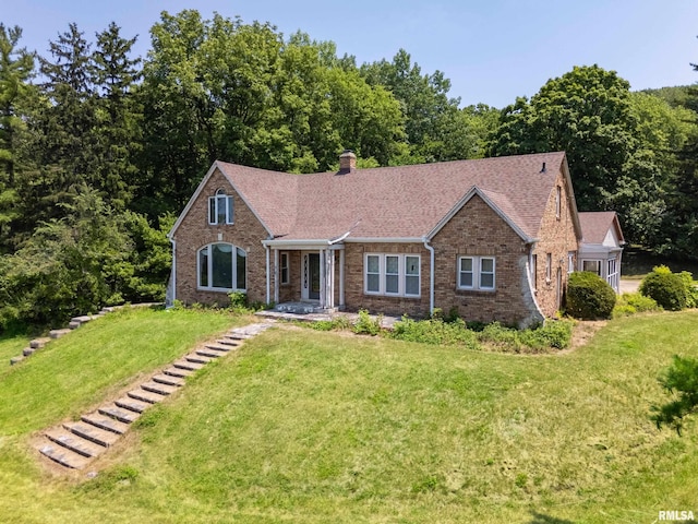 1426 N Main St, East Peoria, IL 61611 - view of front of property with a front yard, brick siding, a chimney, and a shingled roof