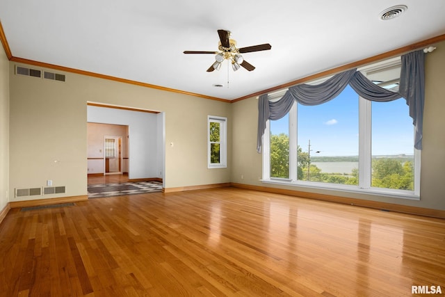1426 N Main St, East Peoria, IL 61611 - empty room featuring light wood-style floors, crown molding, and a ceiling fan