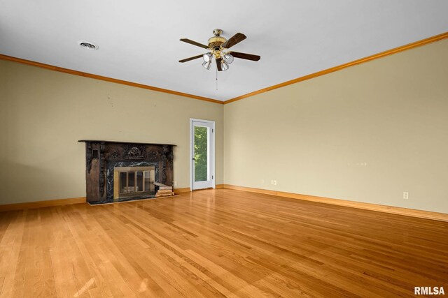1426 N Main St, East Peoria, IL 61611 - unfurnished living room with wood finished floors, a fireplace, a ceiling fan, and ornamental molding