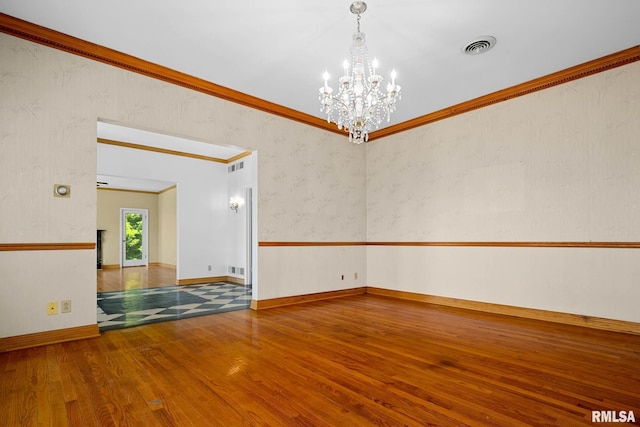 1426 N Main St, East Peoria, IL 61611 - unfurnished room with wood finished floors, a chandelier, and crown molding