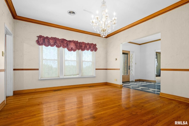 1426 N Main St, East Peoria, IL 61611 - empty room featuring a chandelier, wood finished floors, and crown molding