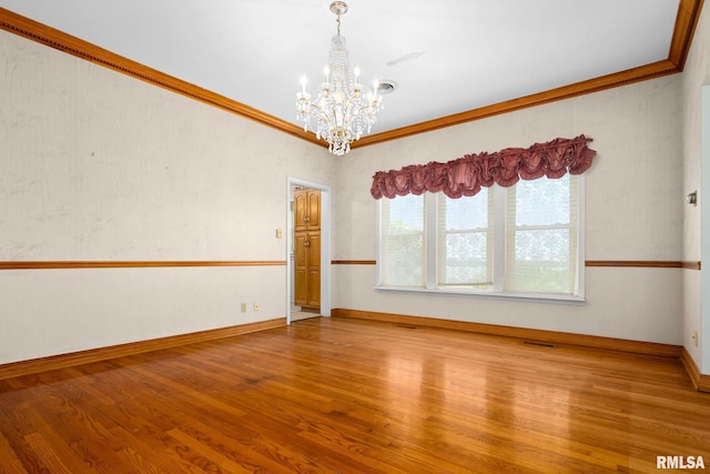 1426 N Main St, East Peoria, IL 61611 - empty room with a chandelier, wood finished floors, and ornamental molding