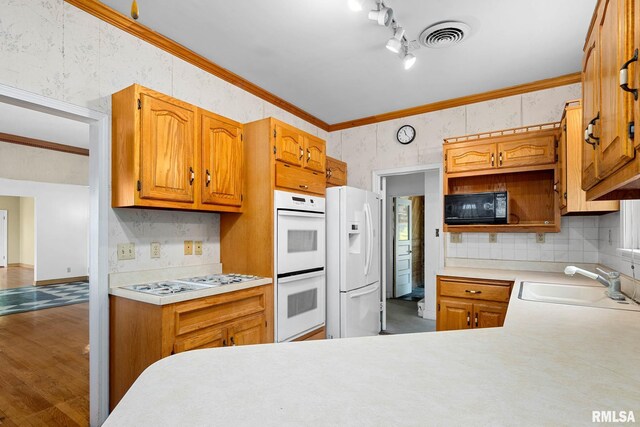1426 N Main St, East Peoria, IL 61611 - kitchen with white appliances, light countertops, tasteful backsplash, ornamental molding, and brown cabinets