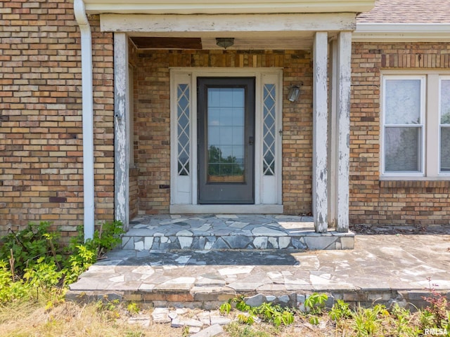 1426 N Main St, East Peoria, IL 61611 - property entrance featuring brick siding and a porch