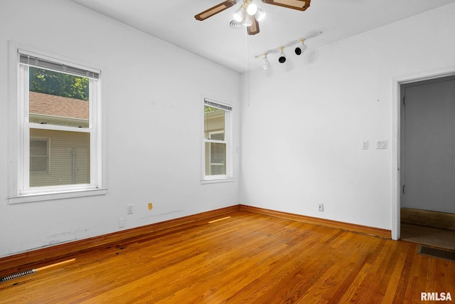 1426 N Main St, East Peoria, IL 61611 - spare room featuring a ceiling fan, rail lighting, and wood finished floors