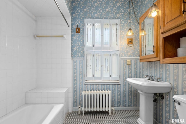 1426 N Main St, East Peoria, IL 61611 - full bathroom with radiator heating unit, wallpapered walls, tile patterned flooring, and washtub / shower combination