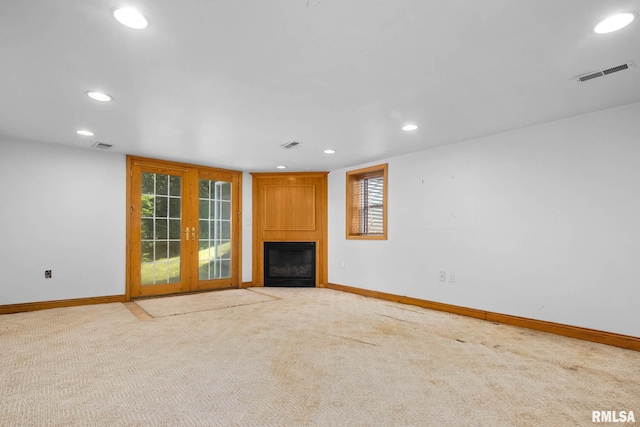 1426 N Main St, East Peoria, IL 61611 - unfurnished living room with recessed lighting, a fireplace, carpet flooring, and french doors