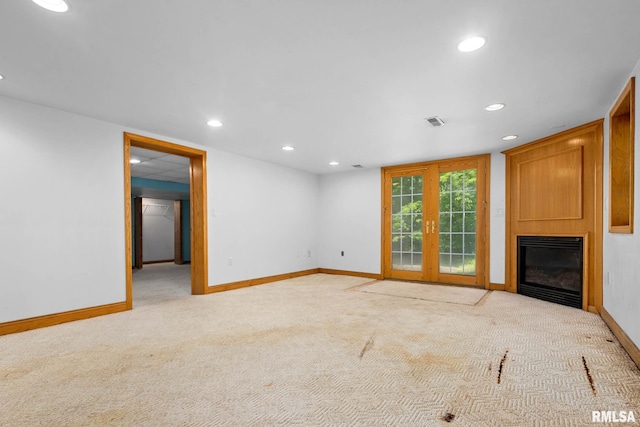 1426 N Main St, East Peoria, IL 61611 - unfurnished living room featuring a large fireplace, recessed lighting, light colored carpet, and french doors