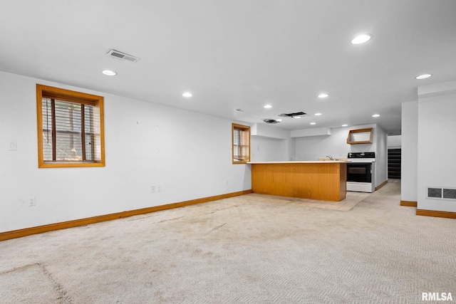 1426 N Main St, East Peoria, IL 61611 - unfurnished living room featuring recessed lighting, light colored carpet, and bar area