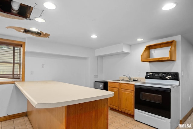 1426 N Main St, East Peoria, IL 61611 - kitchen with white electric stove, a peninsula, light tile patterned flooring, light countertops, and recessed lighting